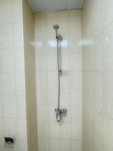 a shower with a shower head in a bathroom at RksHome Studio Apartment Baniyas Metro Exit 2 in Dubai