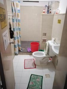 a bathroom with a toilet and a sink at Bugoy Bikers Hostel in Cebu City