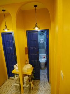 a bathroom with two blue doors and a toilet at Vientiane town centre in Vientiane