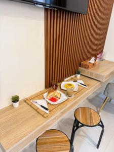 a wooden table with plates of food on it at RksHome Studio Apartment Baniyas Metro Exit 2 in Dubai