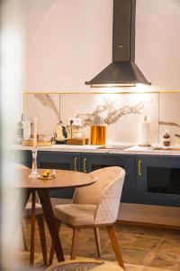 a kitchen with blue cabinets and a table and chairs at Opera apartments - Mestský palác in Banská Štiavnica