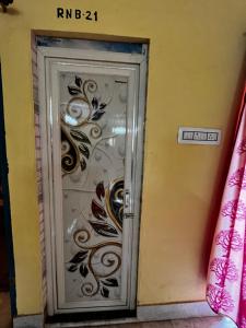 a door with a floral design on it at RATNA NIBAS 
