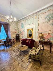 a living room with a couch and a table at Opera apartments - Mestský palác in Banská Štiavnica +168 photos