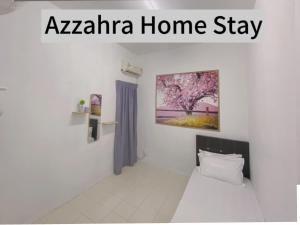 a room with a bed and a painting on the wall at Az-zahra Home Stay Kulim Hi-Tech in Kulim