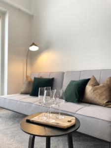 a living room with a couch with wine glasses on a table at Beautiful loft apartment with glazed balcony in Tampere