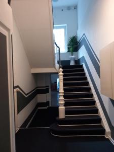 een trap met blauwe en witte trappen met een plant bij Hotel Karolinger in Düsseldorf