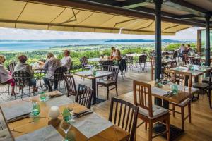a group of people sitting at tables in a restaurant at Studio in Csopak - Balaton 48108 in Csopak