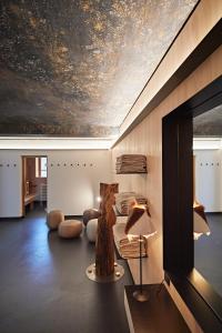 un salon avec un grand tableau au plafond dans l'établissement Chalet Apartment Oswalda-Hus, à Riezlern