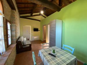 a living room with a table and a couch at Venturo Agriturismo Restaurant & Horses in Castelnuovo di Garfagnana