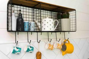 a shelf with cups and utensils on a wall at The Apiary in Killarney