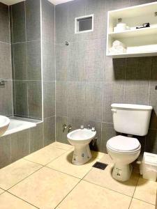 a bathroom with a toilet and a sink at Hermoso y cómodo departamento en Salta in Salta +6 photos