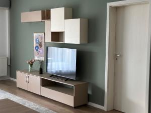 a living room with a television on a cabinet at MM Residence in Cluj-Napoca