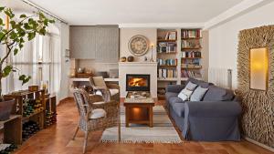 a living room with a couch and a fireplace at Boutique Hotel Cortijo El Sarmiento in Mojácar