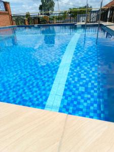 a swimming pool with blue tiles on it at Kigali Peace vill in Kigali