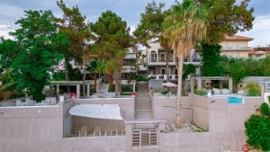 a view of a building with stairs and trees at Ktima Papaoikonomou 2 in Potos