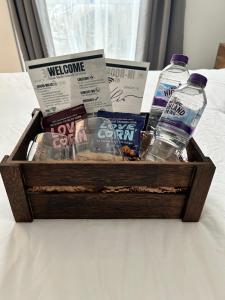 a wooden crate with books and water bottles on a bed at My Apartment Brixton - Modern Double Room with En-suite in London