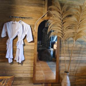 a white robe hanging on a wall in a room at Beyond Heaven in Tampaksiring