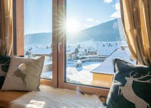 a window with a view of a snowy mountain at Schitter-Appartements in Mauterndorf