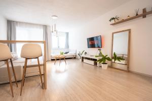 a living room with a table and a mirror at Apartmán Belveder s terasou in Banská Bystrica