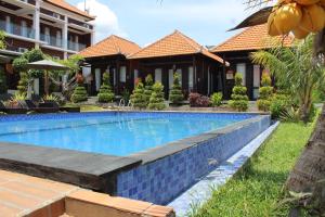 a swimming pool in front of a resort at Nusa Sedayu Hotel By Ocean View in Nusa Penida