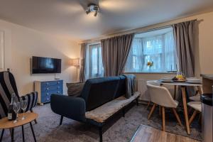 a living room with a chair and a table at Pass the Keys Modern Ground Floor Apartment in Shifnal