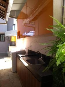 a kitchen with a sink and a counter top at Apartamento e Suítes Mobiliada Climatizada Campo Grande in Recife