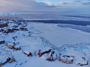 an aerial view of a village in the snow at Modern seaview house Ilulissat in Ilulissat
