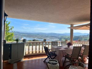 a balcony with a table and chairs and a view at VILLA OSTRERA in Suances