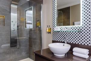 a bathroom with a sink and a shower at Killarney Oaks Hotel in Killarney