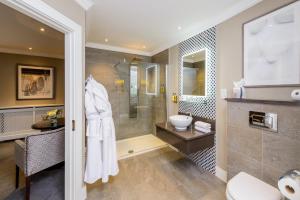 a bathroom with a shower and a toilet and a sink at Killarney Oaks Hotel in Killarney