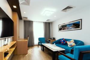 a living room with a blue couch and a table at Prudential Hotel Nepal in Kathmandu