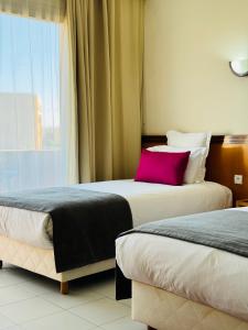 Uma cama ou camas num quarto em Hotel Idou Tiznit