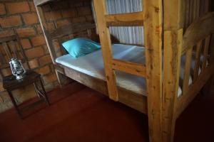 a room with two bunk beds and a table at Chez Antonio in Ampasimena