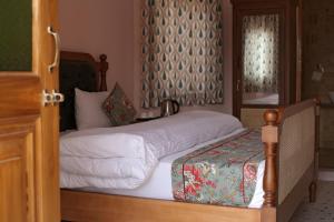 a bedroom with two beds and a window at KothiPushkar in Pushkar