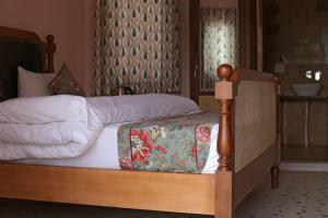 a bedroom with two beds with white sheets at KothiPushkar in Pushkar