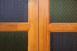 a wooden door with two glass windows in a room at KothiPushkar in Pushkar