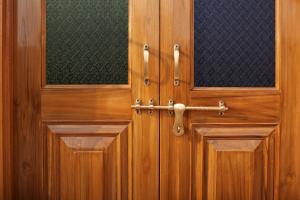 a close up of a wooden door with a handle at KothiPushkar in Pushkar