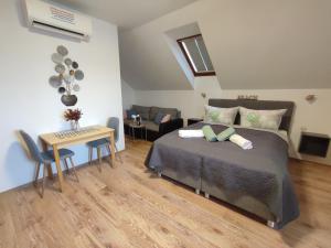 a bedroom with a bed and a table with chairs at Haus Marika in Siófok +160 photos