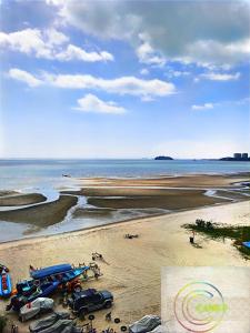 a beach with a boat and vehicles on the sand at Bidadari Lagoon 4 Islamic Homestay in Port Dickson +51 photos