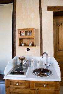 a kitchen counter with a sink and a stove at Anassa Townhouse, In Rethymno's old city center in Rethymno