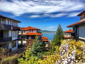 a row of houses with a lake in the background at Санта Марина-Сладка къща in Sozopol