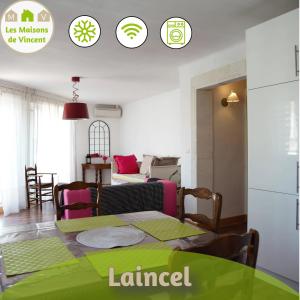 a living room with a table and a couch at Laincel - Clim - Balcon in Arles
