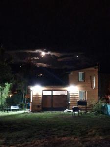 a house at night with lights in the yard at Cabaña Bigua in San Martín de los Andes