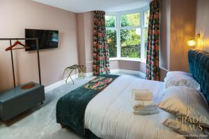 a bedroom with a large bed and a window at Fair Rigg by Cradel Haus - Ultra Luxury Lakes Holiday Homes, Pet Friendly, Parking & EV Plug in Bowness-on-Windermere