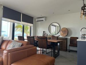 a living room with a couch and a table and a mirror at Luxury Beach Villa, Praia de Chaves, Boa Vista in Boa Ventura