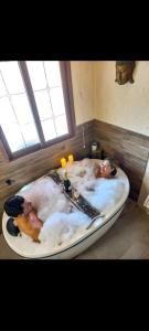 two people in a bath tub in a bathroom at Recanto Zen Praia do Rosa in Praia do Rosa