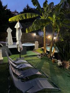 a yard with a chair and a table with a umbrella at Petit coin de paradis in Menton