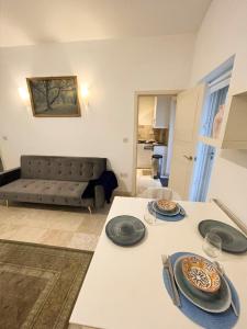 a living room with a table with plates on it at Apartment moments from Hyde Park in London