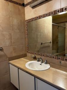 a bathroom with a sink and a mirror at Oportunidad González Suárez, Quito in Quito