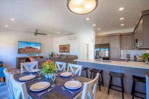 a dining room and kitchen with a table and chairs at 19| Vue at Green Valley with Community Pool in St. George